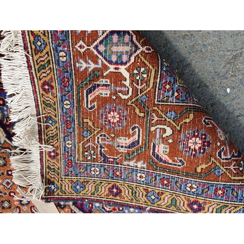 382 - A Persian woollen Rug with pale blue central lozenge on peach ground decorated with stylised flowers... 