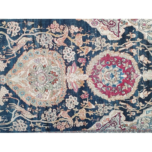 383 - A fine cotton Persian Rug with floral motifs to the multiple borders, the central design of exotic b... 