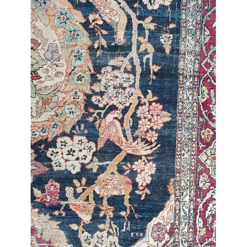 383 - A fine cotton Persian Rug with floral motifs to the multiple borders, the central design of exotic b... 