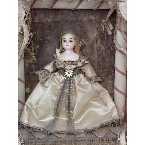 395A - A 19th Century Doll's Diorama with porcelain headed Doll in silk dress standing on stage with theatr... 