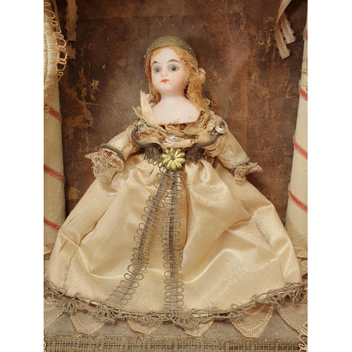 395A - A 19th Century Doll's Diorama with porcelain headed Doll in silk dress standing on stage with theatr... 