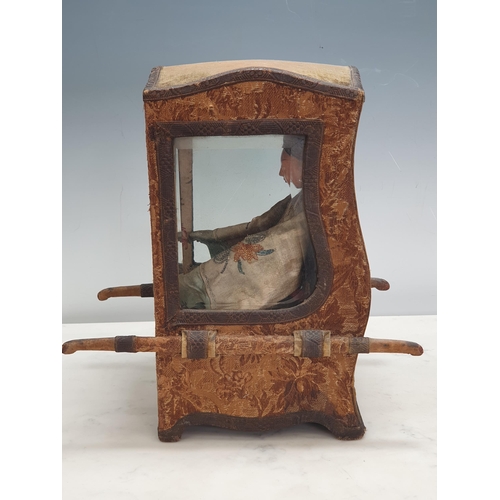 396 - A Doll's Sedan Chair with shaped top, bevelled glass panels, the outside covered in floral tapestry ... 