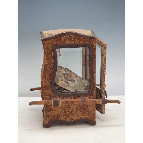 396 - A Doll's Sedan Chair with shaped top, bevelled glass panels, the outside covered in floral tapestry ... 