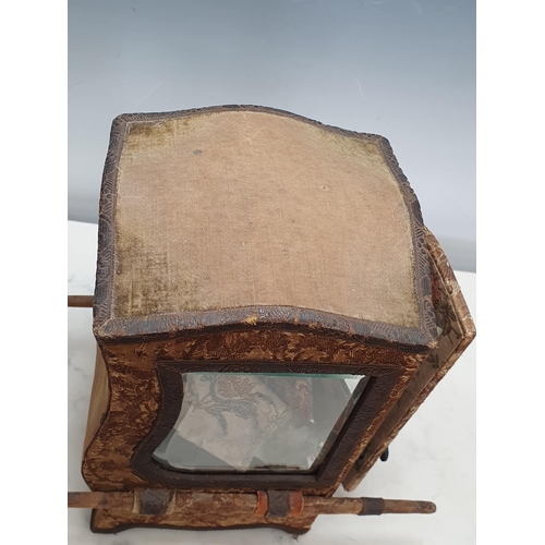 396 - A Doll's Sedan Chair with shaped top, bevelled glass panels, the outside covered in floral tapestry ... 