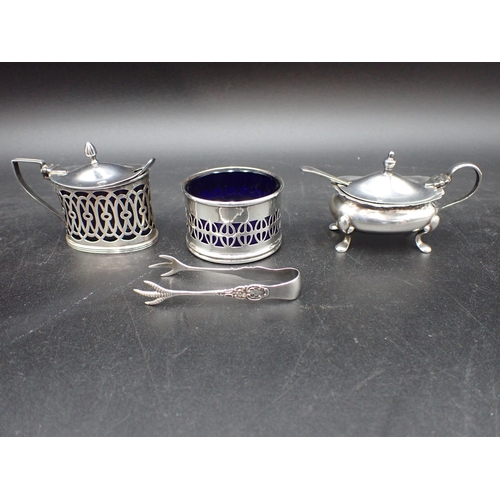 43 - Two silver Mustard Pots, a pierced circular Salt, Salt Spoon and Sugar Claws