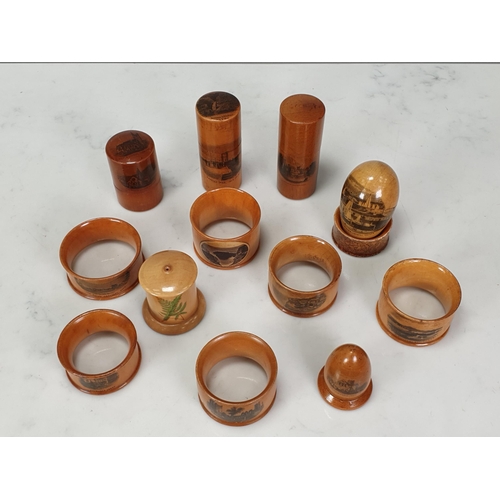 443 - A group of Mauchlin-ware including seven Napkin Rings, mostly named, a Thimble Case 'St Cadvans, Tow... 