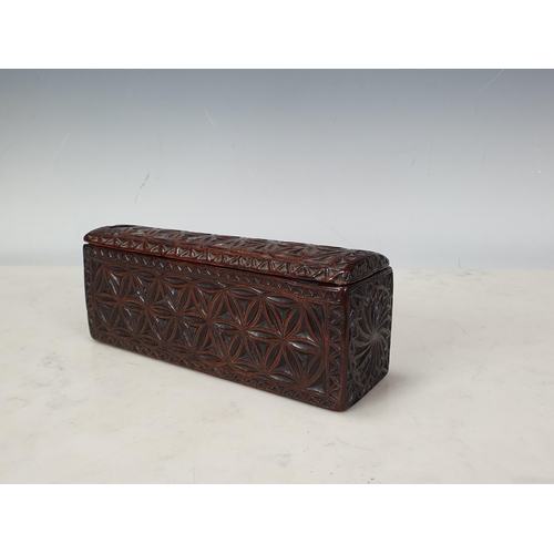 448 - A chip-carved rectangular Box with sliding cover, hollowed from a single piece of possibly chestnut,... 