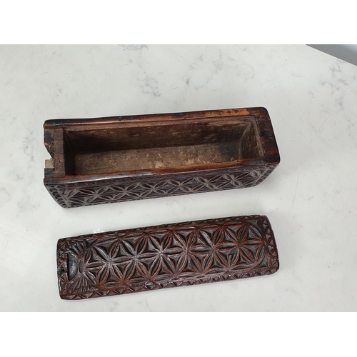 448 - A chip-carved rectangular Box with sliding cover, hollowed from a single piece of possibly chestnut,... 