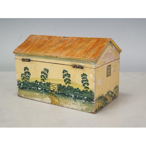 450 - A Folk Art Work Box in the form of a cottage with painted design, the pitched roof hinged cover cont... 