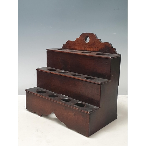 477 - An 18th Century Welsh oak Spoon Rack with raised shaped top, three tiers, cupids bow cut out design ... 