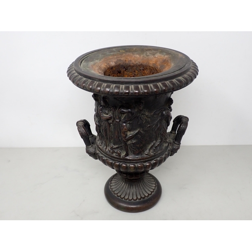 484 - A bronze two-handled Classical Urn with frieze of figures, gadroon base with mask handles, 8½in