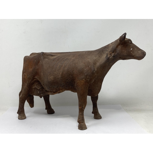 486 - An antique cast iron Figure of a Dairy Cow with hole in underside for mounting, 15in L x 10in H