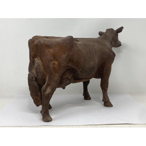 486 - An antique cast iron Figure of a Dairy Cow with hole in underside for mounting, 15in L x 10in H