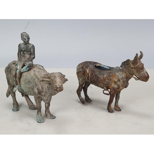 505 - A bronze Figure of a young man sat on a buffalo, 6in L and a bronze Figure of a donkey, 5 1/2in lack... 