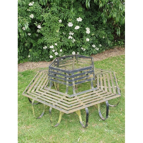 513 - A black painted wrought iron Tree Seat in two sections to surround a tree, with horizontal slats on ... 