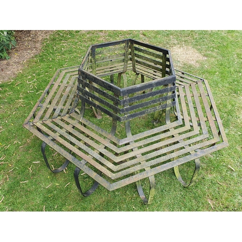 513 - A black painted wrought iron Tree Seat in two sections to surround a tree, with horizontal slats on ... 