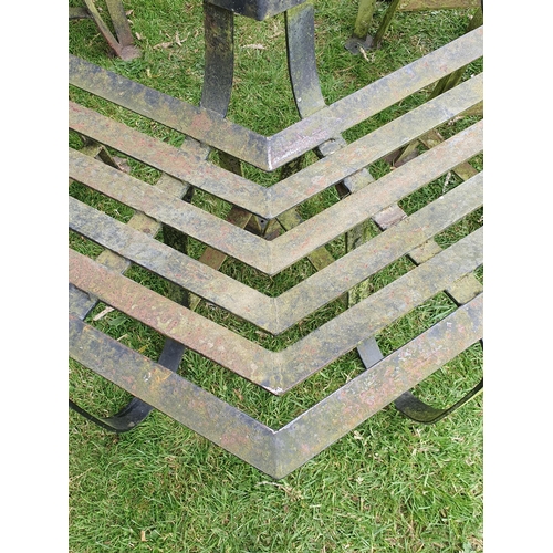 513 - A black painted wrought iron Tree Seat in two sections to surround a tree, with horizontal slats on ... 