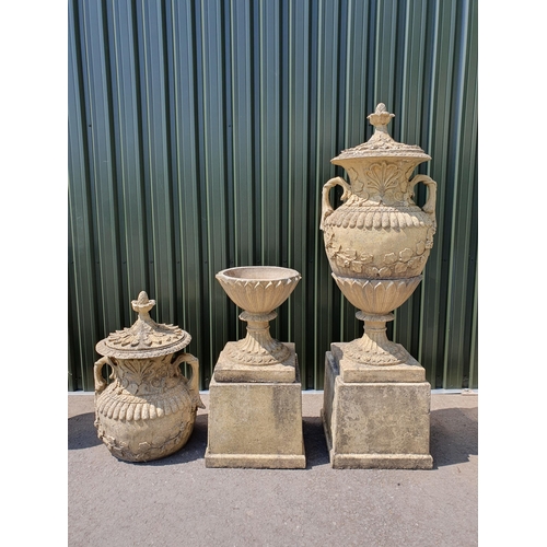 514 - A large pair of reconstituted Garden Urns and Covers on pedestal and plinth bases, having pineapple ... 