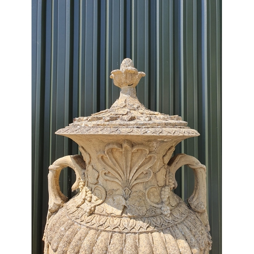 514 - A large pair of reconstituted Garden Urns and Covers on pedestal and plinth bases, having pineapple ... 