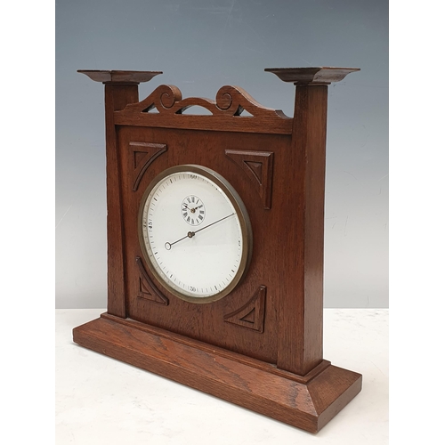 521 - An Arts and Crafts style oak Mantel Clock the circular dial and pierced surmount, 14in H