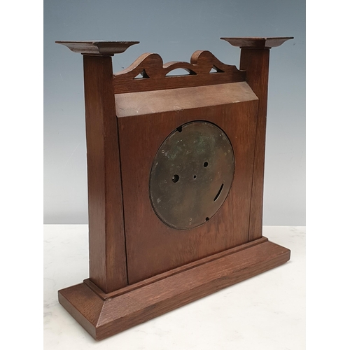 521 - An Arts and Crafts style oak Mantel Clock the circular dial and pierced surmount, 14in H