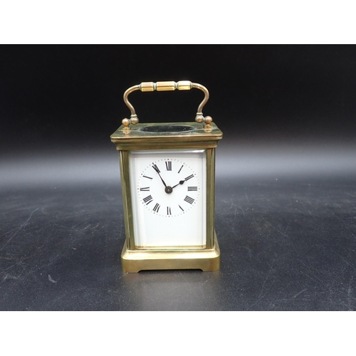 522 - A brass cased Carriage Clock with white enamel dial, cylinder escapement, 5in, in original travellin... 