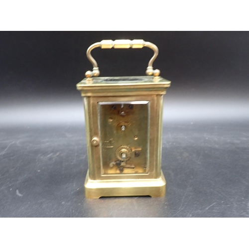 522 - A brass cased Carriage Clock with white enamel dial, cylinder escapement, 5in, in original travellin... 