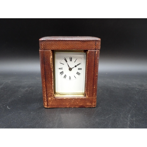 522 - A brass cased Carriage Clock with white enamel dial, cylinder escapement, 5in, in original travellin... 