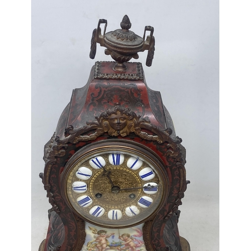 526 - A Boulle work Mantel Clock having urn finial, the circular dial with enamel panels marked with Roman... 