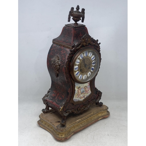 526 - A Boulle work Mantel Clock having urn finial, the circular dial with enamel panels marked with Roman... 