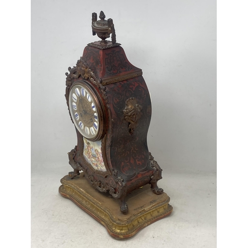 526 - A Boulle work Mantel Clock having urn finial, the circular dial with enamel panels marked with Roman... 