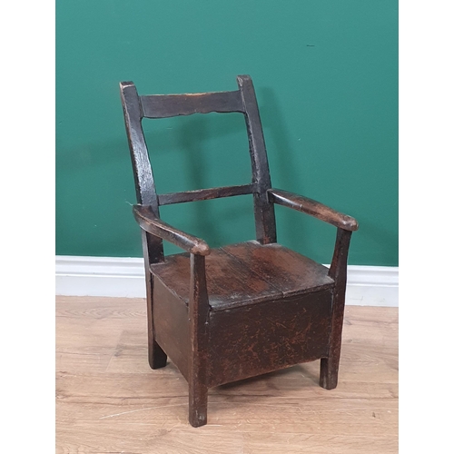 541 - A 19th Century Folk Art stained pine bar-back child's Elbow Chair with box seat (seat top spilt) 1ft... 