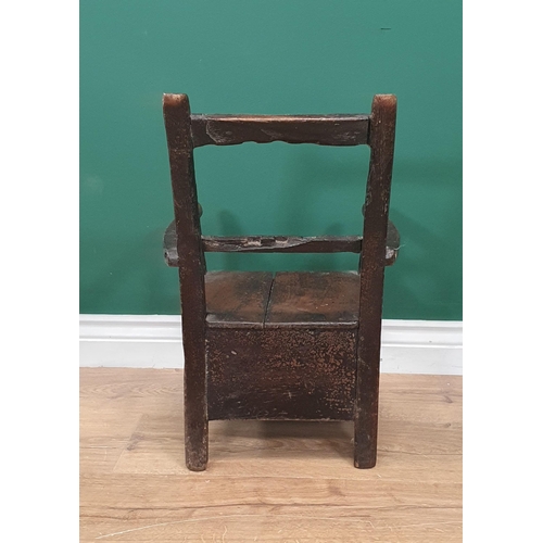 541 - A 19th Century Folk Art stained pine bar-back child's Elbow Chair with box seat (seat top spilt) 1ft... 