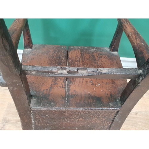 541 - A 19th Century Folk Art stained pine bar-back child's Elbow Chair with box seat (seat top spilt) 1ft... 