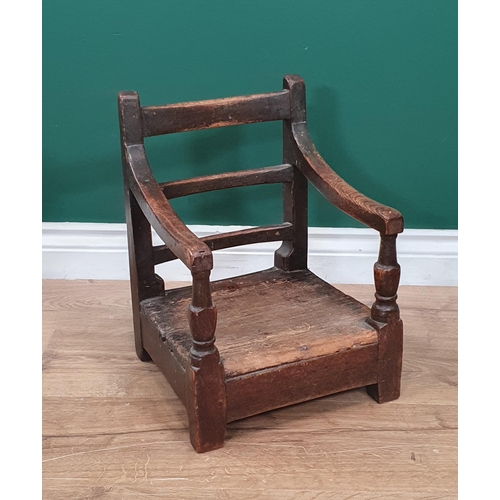 541 - A 19th Century Folk Art stained pine bar-back child's Elbow Chair with box seat (seat top spilt) 1ft... 