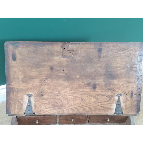 542 - An 18th Century country elm slope fronted Desk Box, the hinged lid enclosing three drawers 1ft 8in W... 