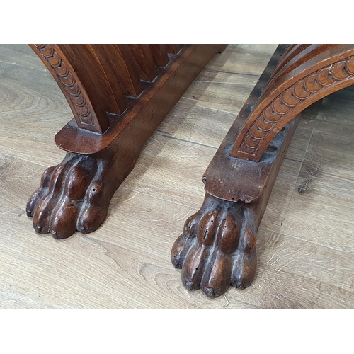 558 - A pair of walnut X-framed Thrones with carved Armorial top rails and trailing floral and ivy leaf de... 