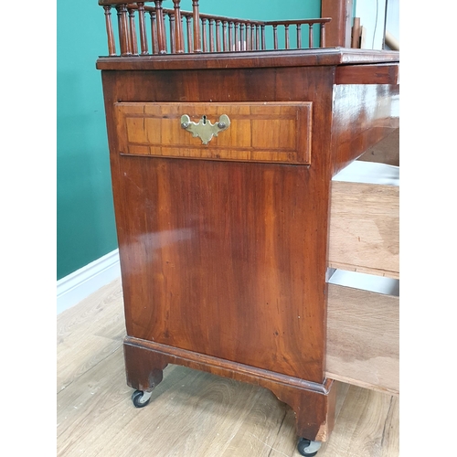 560 - An antique walnut Chest with spindle gallery, brushing slide above two feather banded drawers and tw... 