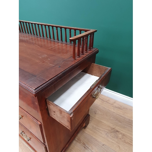 560 - An antique walnut Chest with spindle gallery, brushing slide above two feather banded drawers and tw... 