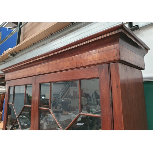 561 - A 19th Century mahogany Bookcase with pair of astragal glazed doors above pair of solid panelled doo... 