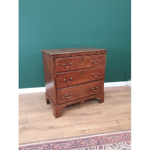 564 - An antique oak Chest of three long graduated drawers with shaped upper frieze, 3ft W