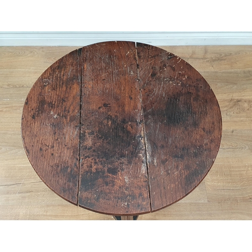 565 - An antique oak Cricket Table with circular top, triangular under tier on three legs, 2ft diam