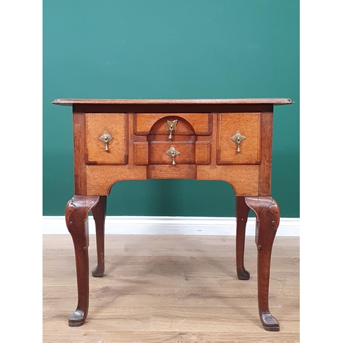 569 - An 18th Century oak Lowboy, the moulded top above four crossbanded drawers forming a block front abo... 