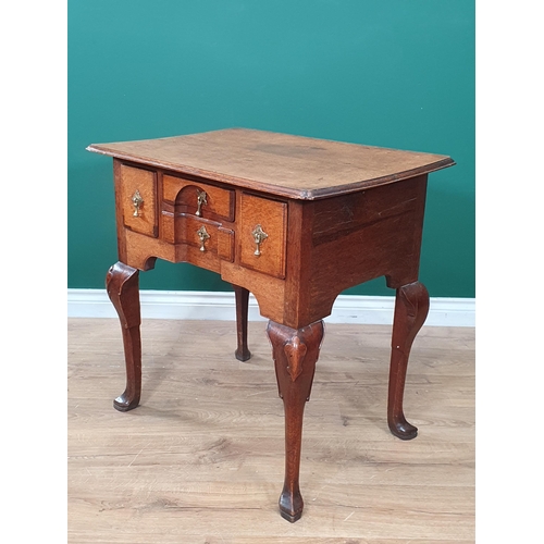 569 - An 18th Century oak Lowboy, the moulded top above four crossbanded drawers forming a block front abo... 