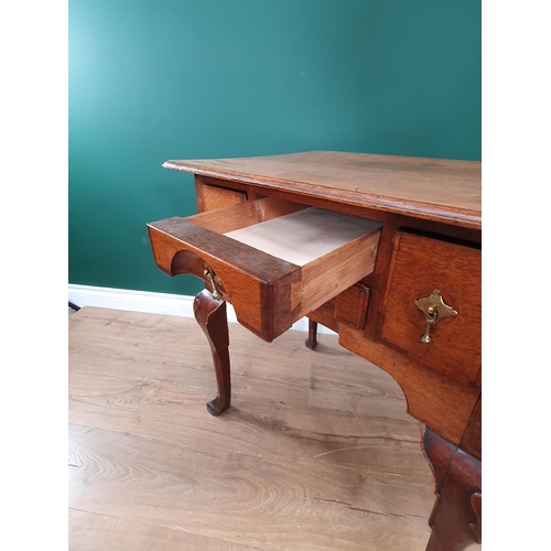 569 - An 18th Century oak Lowboy, the moulded top above four crossbanded drawers forming a block front abo... 