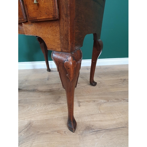 569 - An 18th Century oak Lowboy, the moulded top above four crossbanded drawers forming a block front abo... 