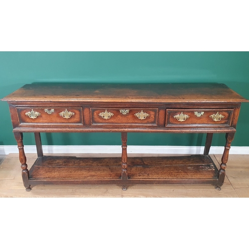 573 - An 18th Century oak Dresser Base fitted three moulded drawers, raised on baluster turned and squared... 