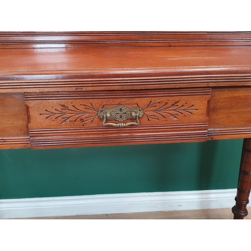 574 - An aesthetic walnut Side Table with raised gallery to the back and fitted a frieze drawer on turned ... 