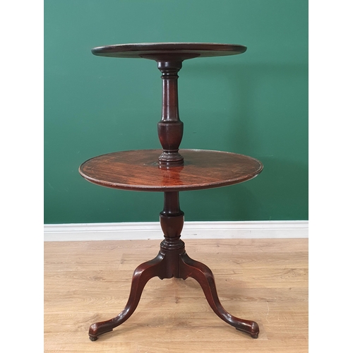 577 - A Georgian mahogany circular graduated two tier Dumb Waiter with dished tiers on baluster turned col... 