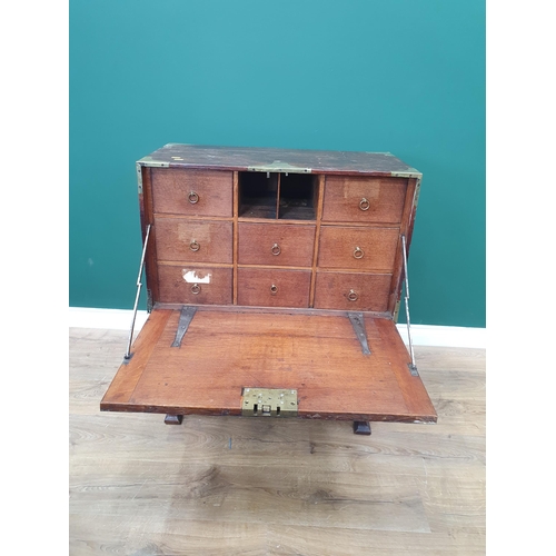 584 - A 19th Century teak and brass bound Campaign Escritoire with fall front enclosing eight drawers with... 